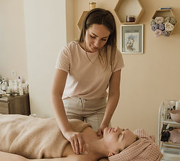 Woman giving a Gua Sha treatment.