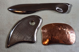 modern gua sha tools and IASTM made from steel and copper.
